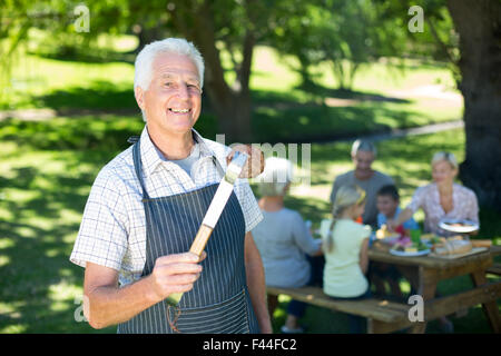 Happy grandfather doing barbecue Stock Photo