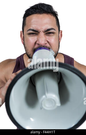 Muscular man yelling through a megaphone Stock Photo