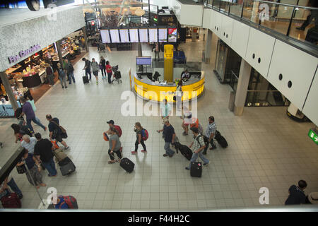 Travelers inside Shiphol International Airport in Amsterdam, Netherlands Stock Photo