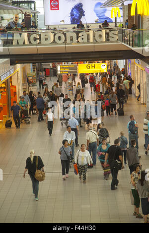 Travelers inside Shiphol International Airport in Amsterdam, Netherlands Stock Photo