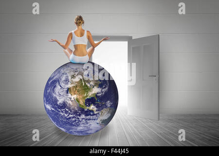 Composite image of fit woman doing yoga Stock Photo