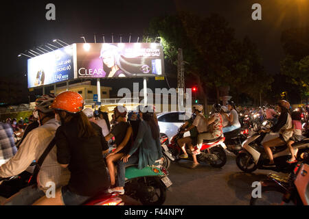 young people teenagers travel on their scooters at night in Ho Chi Minh Saigon city centre,Vietnam. Stock Photo