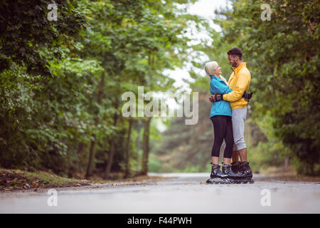 Happy couple roller blading together Stock Photo