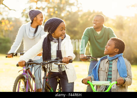 Young smiling family doing a bike ride Stock Photo