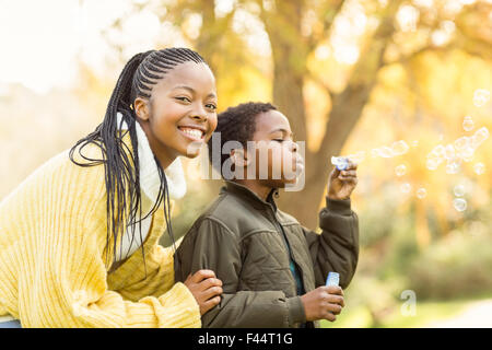 Little boy doing some bubbles with his mother Stock Photo