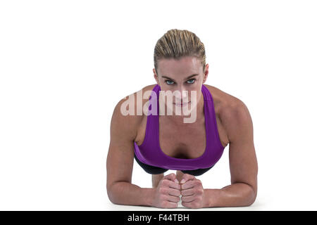 Muscular woman doing push ups Stock Photo