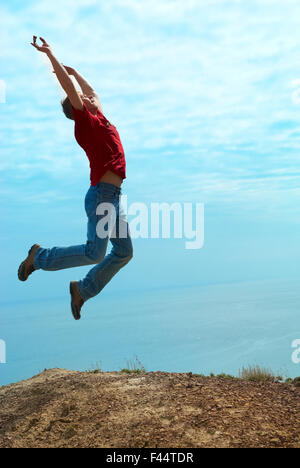 Man jumping cliff Stock Photo