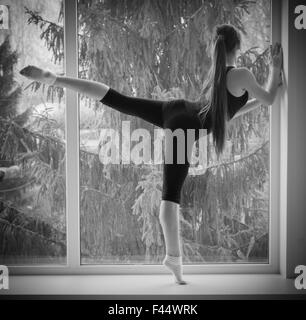 Young dancing girl on window Stock Photo