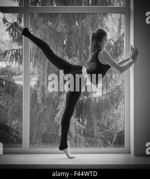 Young dancing girl on window Stock Photo