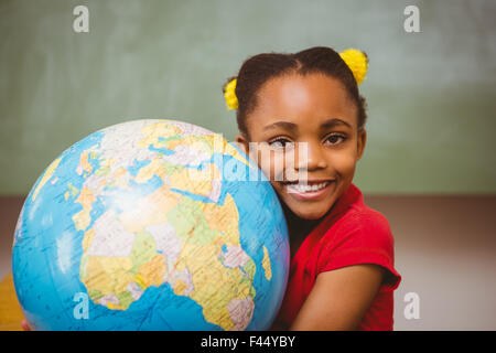 Cute little girl holding globe Stock Photo