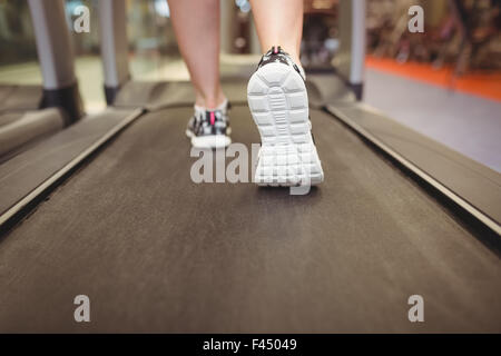 Fit woman running on treadmill Stock Photo