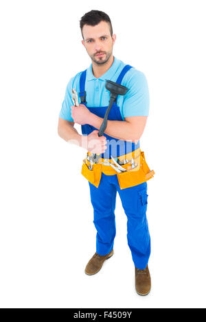 Plumber with plunger and tool belt Stock Photo