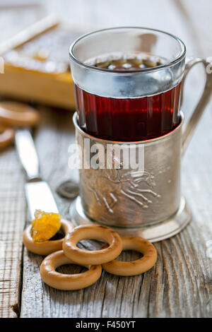 Glass of tea in an old cup holder. Stock Photo