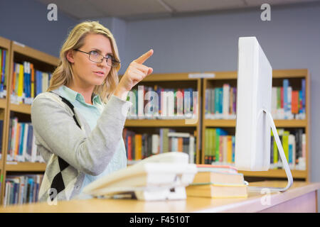 Pretty librarian working in the library Stock Photo