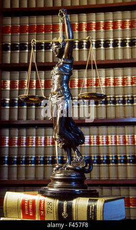 A statue of blindfolded justice holding the scales of justice decorates a California law library. Stock Photo