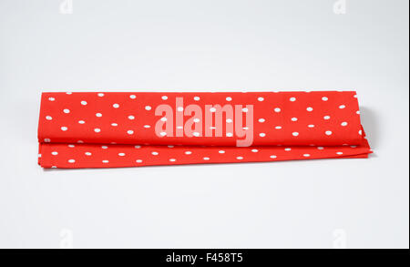 red and white dotted place mat on white background Stock Photo