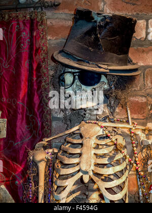 Haitian Voodoo figure Baron Samedi is represented as a skeleton in the New Orleans Voodoo Museum. Note top hat and dark glasses with one lens missing so he can look in two directions at once. Stock Photo