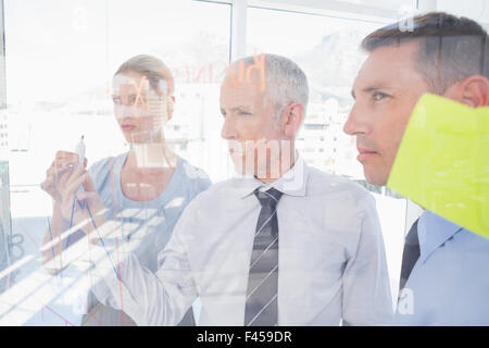 Businessman drawing graph on the glass Stock Photo