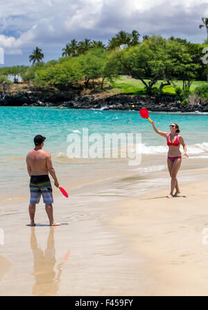 Couple playing paddleball, Hapuna Beach, Kohala Coast, Hawai'i, USA Stock Photo
