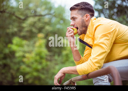 Fit man eating an apple Stock Photo
