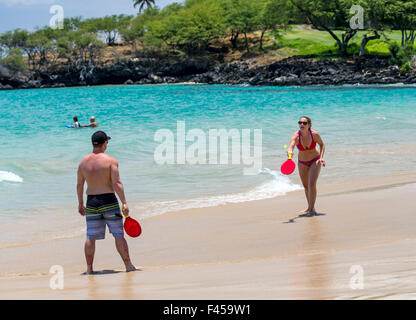 Couple playing paddleball, Hapuna Beach, Kohala Coast, Hawai'i, USA Stock Photo