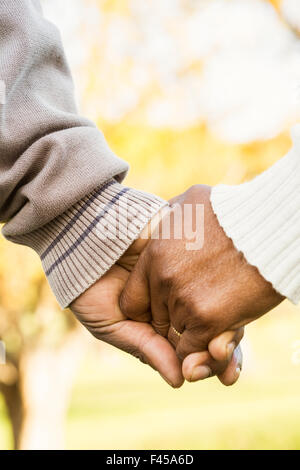 Close up view of senior couple holding hands Stock Photo
