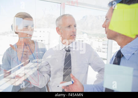 Businessman drawing graph on the glass Stock Photo