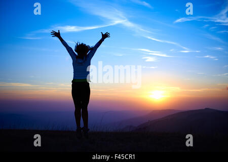 Silhouette of jumping young woman Stock Photo