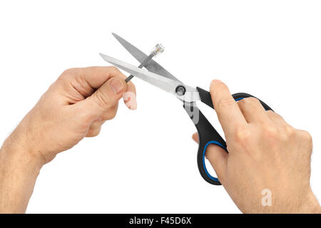Hand with scissors and computer cable Stock Photo