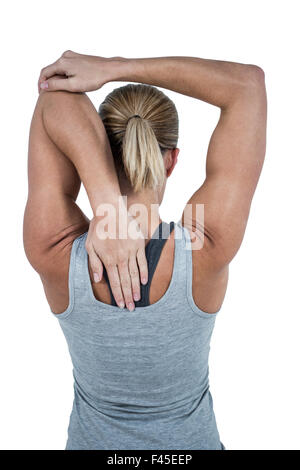 Rear view of muscular woman stretching her arm Stock Photo