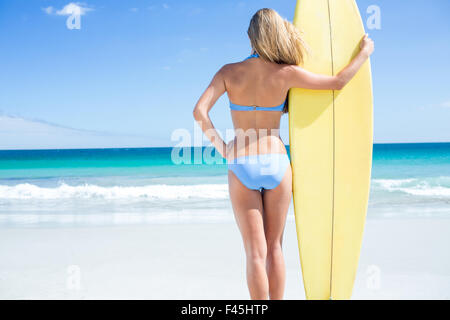 Pretty blonde woman holding surf board Stock Photo