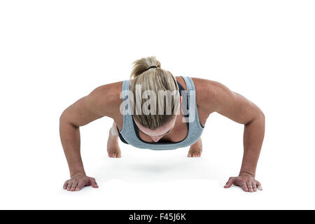 Muscular woman doing push-ups Stock Photo