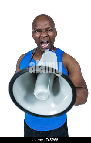 Fit trainer shouting through megaphone Stock Photo