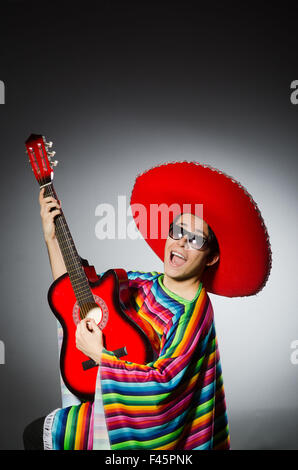 Man in red sombrero playing guitar Stock Photo