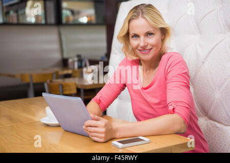 Woman having a coffee using tablet Stock Photo