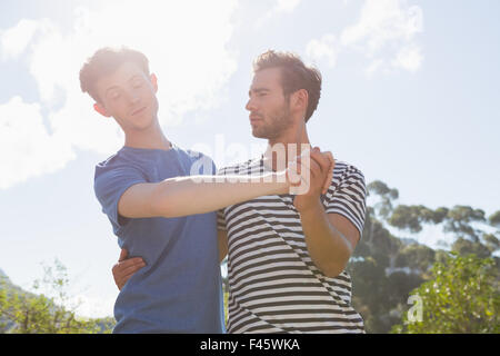 Happy homosexual couple dancing in the garden Stock Photo