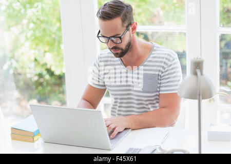 Serious handsome man using laptop computer Stock Photo
