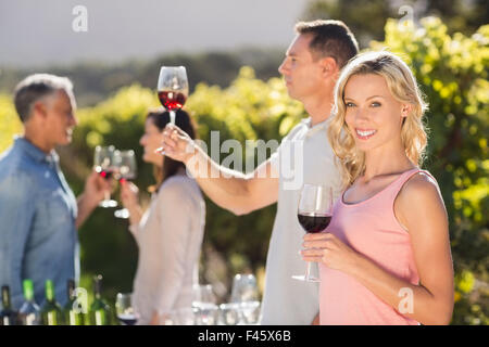 Couple doing wine tasting in front of other couple talking and drinking Stock Photo