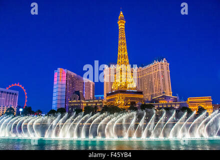 Night view of the dancing fountains of Bellagio and the Eiffel Tower replica of Paris hotel in Las Vegas Stock Photo