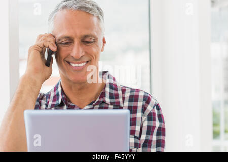 Smiling businessman holding a digital tablet Stock Photo