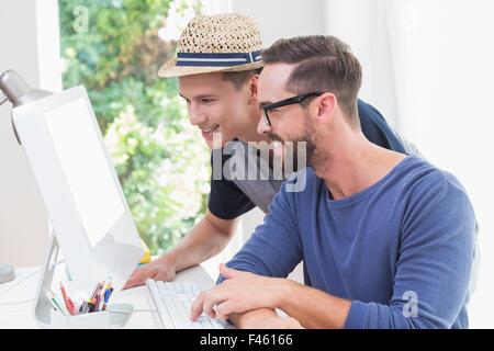Happy homosexual couple working on computer Stock Photo