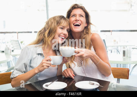 Beautiful women sitting and laughing Stock Photo