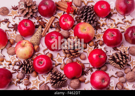 Christmas background. Gingerbread cookies, apples, spices and nuts. Image toned in vintage style. Selective focus. Stock Photo