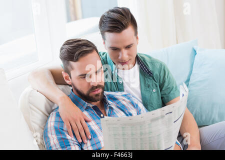 Homosexual couple men reading the newspaper Stock Photo