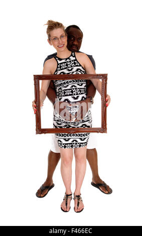 Pregnant couple with picture frame. Stock Photo