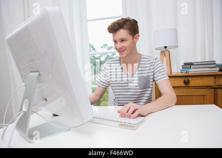 Happy handsome man working on computer Stock Photo