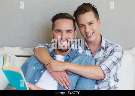 Homosexual couple men reading a book together Stock Photo