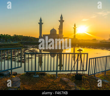 The Tengku Ampuan Jemaah Mosque, Bukit Jelutong, Malaysia mosque silhouetted at sunrise. Stock Photo