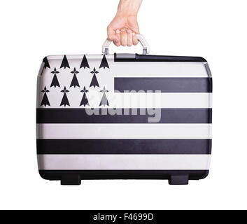 Used plastic suitcase with stains and scratches, printed with flag - Brittany Stock Photo