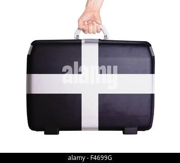 Used plastic suitcase with stains and scratches, printed with flag - Cornwall Stock Photo